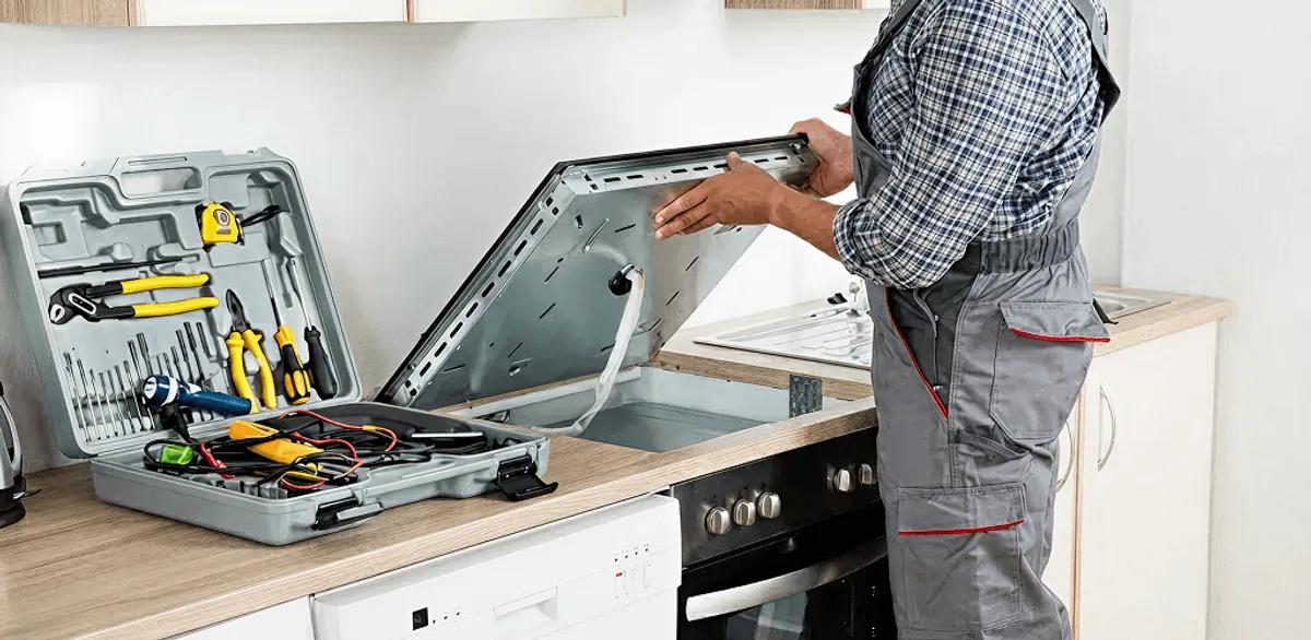 Handyman repairing a cooktop and checking wiring connections in Springfield, MO