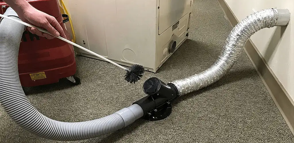 Dryer vent cleaning service removing lint from a dryer duct connection in Springfield, MO