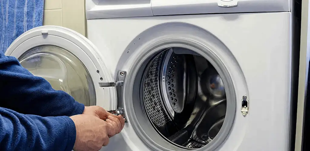 Washing machine repair handyman checking a front-load washer door and latch in Springfield, MO