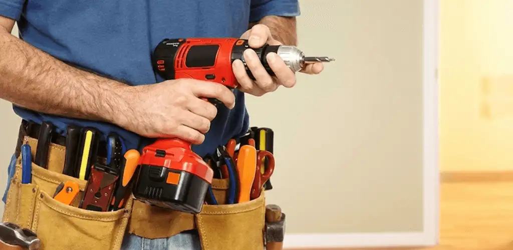 Handyman holding a power drill for home repairs and installations in Springfield, MO