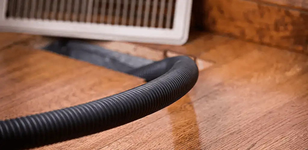 Air duct cleaning hose inserted into a floor vent for ductwork cleaning in Springfield, MO