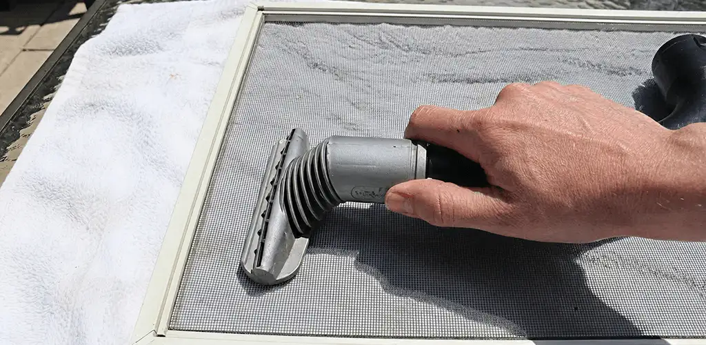 Window screen repair cleaning and fixing a damaged screen mesh in Springfield, MO
